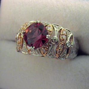 CroppedImage400400 two tone rg garnet ring