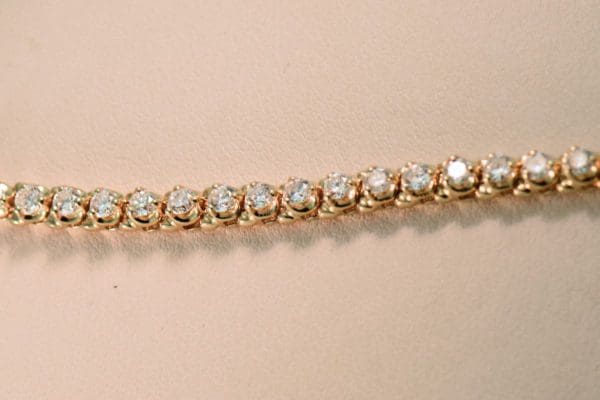 extra fine yellow gold and diamond three prong tennis bracelet 4