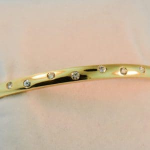 hinged gold bangle bracelet with gypsy set diamonds