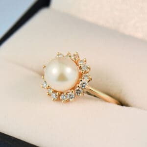 akoya white pearl and diamond halo ring in yellow gold