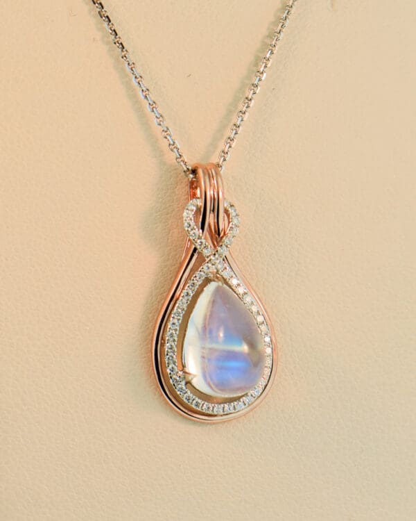 custom rose gold pear pendant with blue moonstone and diamonds