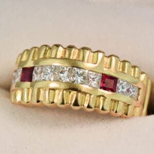 estate yellow gold ring with row of channel set diamonds and rubies