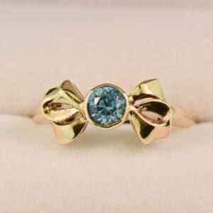 retro gold bow ring with bezel set blue zircon