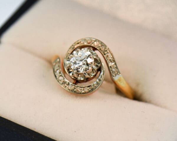 french antique diamond swirl engagement ring with old european cut center