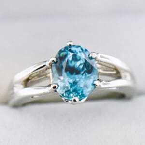 custom blue zircon ring with white gold split shank