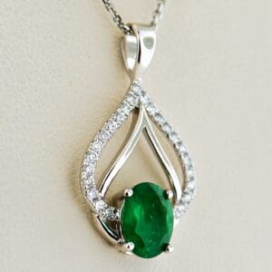 custom white gold and diamond pendant with 1ct zambian emerald