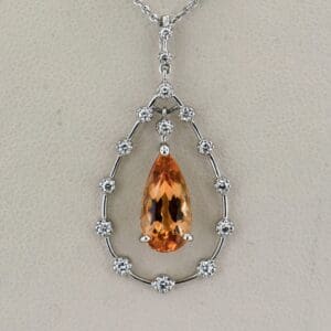 platinum diamond and pear shape imperial topaz pendant