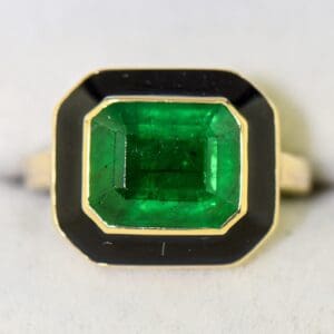 vintage 1980s bezel set ring with deep green emerald and black enamel