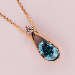 custom slide pendant with flush set blue zircon