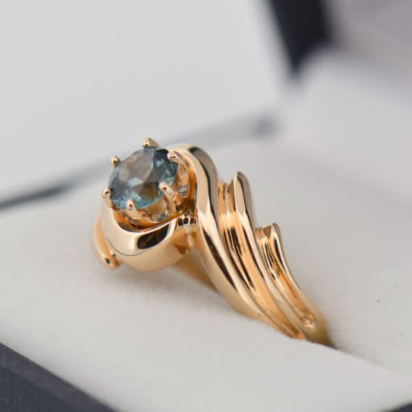 custom yellow gold swirl ring with teal montana sapphire 2