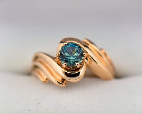 custom yellow gold swirl ring with teal montana sapphire 4