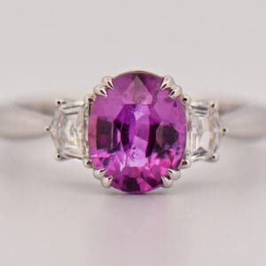 magenta purple sapphire and cadillac diamond three stone ring