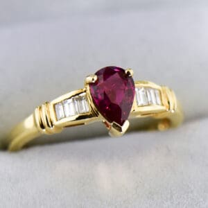 modern estate pear shape ruby ring with baguette diamond accents 2