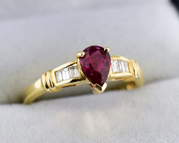 modern estate pear shape ruby ring with baguette diamond accents 2