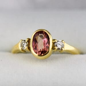 bezel set pink imperial topaz and diamond 3 stone ring