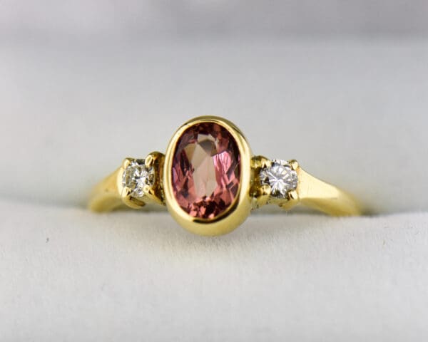 bezel set pink imperial topaz and diamond 3 stone ring