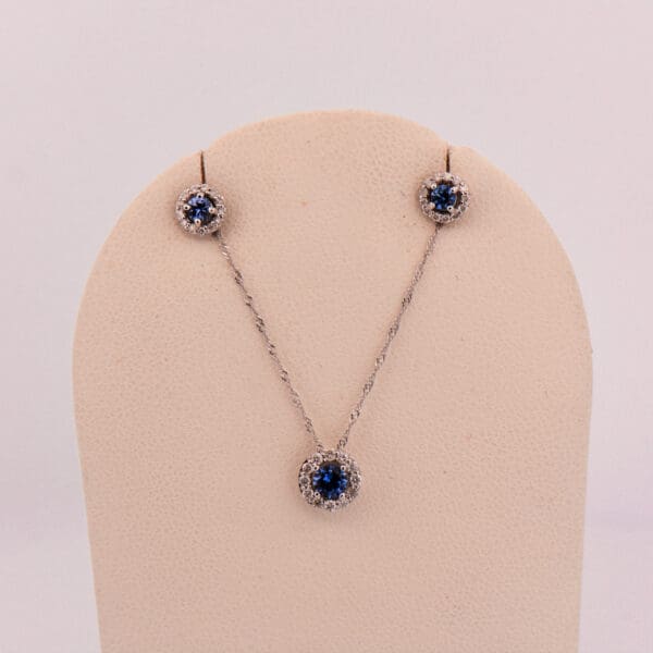 montana blue yogo sapphire and diamond halo pendant and earring set