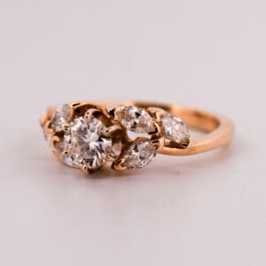 yellow gold engagment ring with round diamond and marquise diamond accents 3