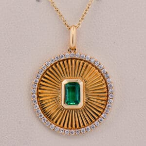 custom sunburst pendant with zambian emerald and diamonds