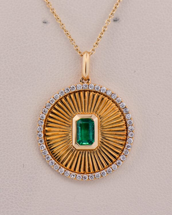 custom sunburst pendant with zambian emerald and diamonds