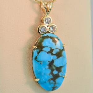 large kingman turquoise and diamond pendant set in yellow gold