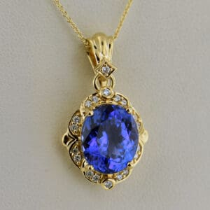 yellow gold pendant set with deep color natural tanzanite and diamonds